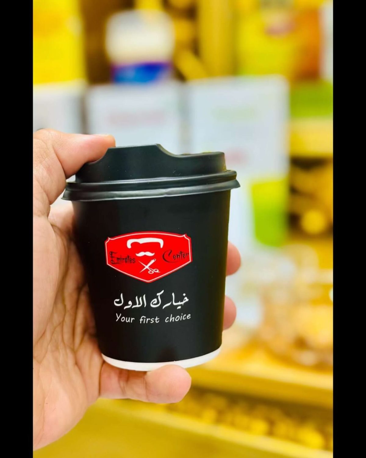 An Emirates Center branded coffee cup served to a guest